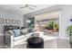 Living room with an open layout connects to a covered patio with stylish outdoor seating and lush greenery at 25311 N 19Th Ln, Phoenix, AZ 85085