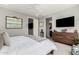 This is the main bedroom with neutral decor, a ceiling fan, and a television at 25311 N 19Th Ln, Phoenix, AZ 85085