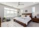 This main bedroom has a large window, a ceiling fan, and neutral decor at 25311 N 19Th Ln, Phoenix, AZ 85085