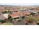 Aerial view of houses in a community with desert landscaping and tile roofs at 27062 W Behrend Dr, Buckeye, AZ 85396