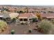 Aerial view of a home with a backyard patio and fire pit at 27062 W Behrend Dr, Buckeye, AZ 85396