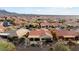 Aerial view of homes in a desert community with mountains in the background at 27062 W Behrend Dr, Buckeye, AZ 85396
