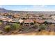 Aerial view of a home in a desert community with mountain views at 27062 W Behrend Dr, Buckeye, AZ 85396