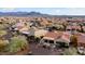 Aerial view of a community with desert landscaping and houses with tile roofs at 27062 W Behrend Dr, Buckeye, AZ 85396
