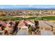 Aerial view of a single-story home with solar panels and mountain views at 27062 W Behrend Dr, Buckeye, AZ 85396