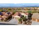 Aerial view of a single-story home with solar panels and a desert landscape at 27062 W Behrend Dr, Buckeye, AZ 85396