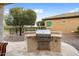 Built-in outdoor kitchen with stainless steel grill at 27062 W Behrend Dr, Buckeye, AZ 85396