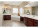 Elegant bathroom with double sinks, soaking tub, and separate shower at 27062 W Behrend Dr, Buckeye, AZ 85396