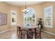 Charming breakfast nook with a round table and chairs near a large window at 27062 W Behrend Dr, Buckeye, AZ 85396