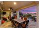 Covered patio with dining table and chairs overlooking the golf course at 27062 W Behrend Dr, Buckeye, AZ 85396