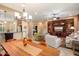 Open dining area with a rustic wooden table and views into the living room at 27062 W Behrend Dr, Buckeye, AZ 85396