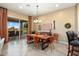 Bright dining room with wooden table and chairs, and access to the backyard at 27062 W Behrend Dr, Buckeye, AZ 85396