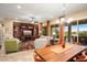 Spacious dining area with a large wooden table and access to the patio at 27062 W Behrend Dr, Buckeye, AZ 85396