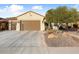 Front view of a house with a brown garage door and desert landscaping at 27062 W Behrend Dr, Buckeye, AZ 85396