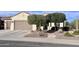 Front view of a house with a brown garage door and desert landscaping at 27062 W Behrend Dr, Buckeye, AZ 85396