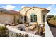 Front patio with seating area and desert landscaping at 27062 W Behrend Dr, Buckeye, AZ 85396