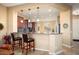 Kitchen breakfast bar with seating for two and views of the living room at 27062 W Behrend Dr, Buckeye, AZ 85396