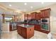 Spacious kitchen with island, granite countertops, and stainless steel appliances at 27062 W Behrend Dr, Buckeye, AZ 85396