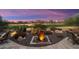 Landscaped backyard with water feature and seating area at 27062 W Behrend Dr, Buckeye, AZ 85396