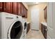 Laundry room with washer, dryer, and extra cabinets at 27062 W Behrend Dr, Buckeye, AZ 85396