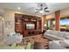 Bright living room with built-in entertainment center and comfy seating at 27062 W Behrend Dr, Buckeye, AZ 85396