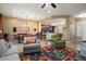 Open living room with hardwood floors, a large area rug, and comfortable seating at 27062 W Behrend Dr, Buckeye, AZ 85396