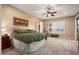 Large main bedroom with neutral decor, a king-size bed and sliding door access to the backyard at 27062 W Behrend Dr, Buckeye, AZ 85396