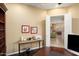 Home office with built-in shelves, desk, and view into the living area at 27062 W Behrend Dr, Buckeye, AZ 85396