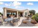 Spacious backyard patio with seating, fire pit, and golf course view at 27062 W Behrend Dr, Buckeye, AZ 85396