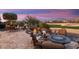 Comfortable patio seating area with fire pit and views at 27062 W Behrend Dr, Buckeye, AZ 85396
