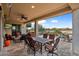 Covered patio with seating area, offering a view of the golf course at 27062 W Behrend Dr, Buckeye, AZ 85396
