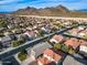 Aerial view of a suburban neighborhood with houses and mountains in the background at 29762 N 69Th Ln, Peoria, AZ 85383