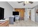 Bedroom with desk, large TV, and access to bathroom at 3144 N 81St Dr, Phoenix, AZ 85033
