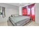 Spacious bedroom with king-size bed and red curtains at 3144 N 81St Dr, Phoenix, AZ 85033