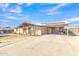 House exterior featuring a carport, mature trees, and a large yard at 3144 N 81St Dr, Phoenix, AZ 85033