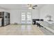 Kitchen with stainless steel refrigerator and French doors to backyard at 3144 N 81St Dr, Phoenix, AZ 85033