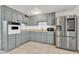 Galley style kitchen with stainless steel appliances and ample cabinetry at 3144 N 81St Dr, Phoenix, AZ 85033
