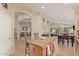 Open kitchen with granite island, breakfast bar, and views into Gathering room at 37110 W Leonessa Ave, Maricopa, AZ 85138
