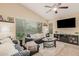 Modern living room with leather furniture and large TV at 37110 W Leonessa Ave, Maricopa, AZ 85138