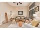 Spacious living room featuring a comfy sofa and large windows at 37110 W Leonessa Ave, Maricopa, AZ 85138