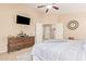 Spacious main bedroom with dresser, large bed, and access to hallway at 37110 W Leonessa Ave, Maricopa, AZ 85138