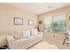 Home office with light beige sofa and built-in bookcase at 37110 W Leonessa Ave, Maricopa, AZ 85138