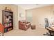 Home office with brown leather couch and a work desk at 37110 W Leonessa Ave, Maricopa, AZ 85138
