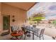 Covered patio with table and chairs, overlooking backyard at 37110 W Leonessa Ave, Maricopa, AZ 85138