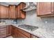Kitchen with gas cooktop and gray brick backsplash at 3841 E Patrick St, Gilbert, AZ 85295