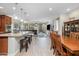 Open concept kitchen features granite countertops, stainless steel appliances, and an island at 3841 E Patrick St, Gilbert, AZ 85295