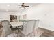 Dining room with a large wooden table and eight gray upholstered chairs at 43459 N Terrace View Ave, San Tan Valley, AZ 85140