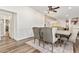 Bright dining room features a large wooden table with six gray upholstered chairs at 43459 N Terrace View Ave, San Tan Valley, AZ 85140