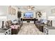Living room with comfy seating and a large TV above the fireplace at 43459 N Terrace View Ave, San Tan Valley, AZ 85140