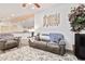 Open living room with a comfortable couch and view into the kitchen at 43459 N Terrace View Ave, San Tan Valley, AZ 85140